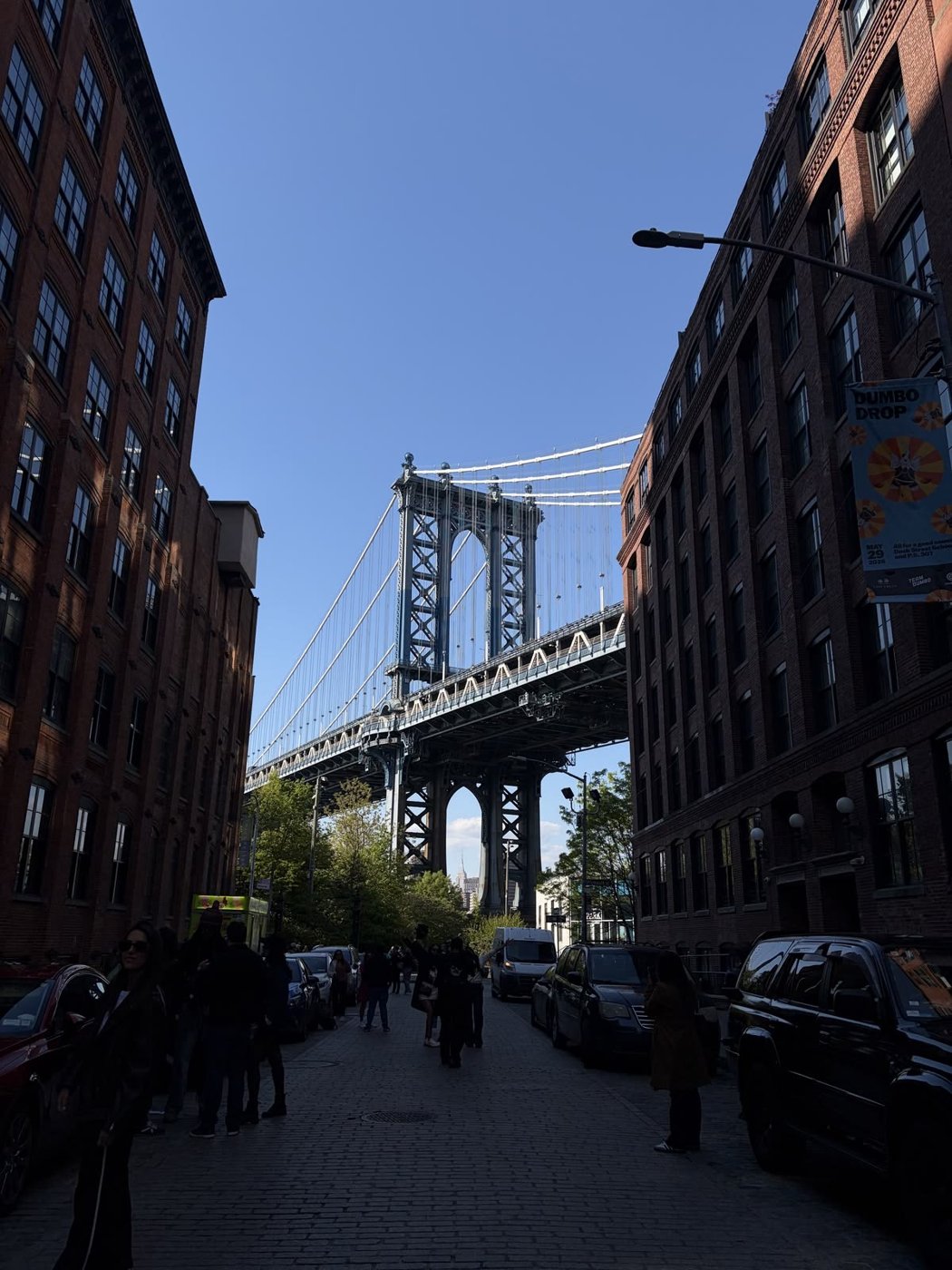 Manhattan Bridge framed by brick buildings in Dumbo, Brooklyn